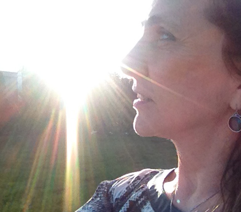 Profile picture of Elizabeth Madden with a reflection from the sun